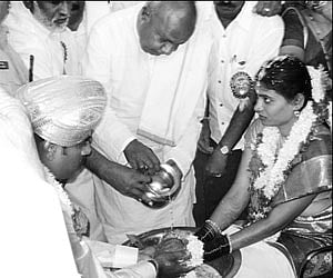 Former prime minister HD Deve Gowda blessing new couple - Varun and Manasa, local legislator Shivalinge Gowda’s daughter - at the mass marriage in Ars