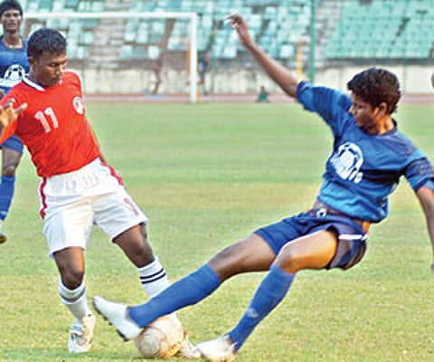 TN Police’s K Ramaunan (left) vies for the ball with Chennai Football Club’s A Surya at the JN Stadium. EPS