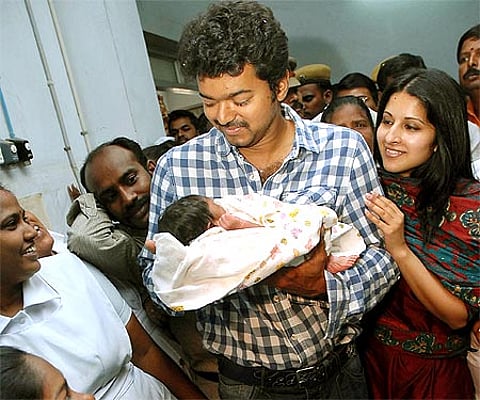 Actor Vijay and wife Sangeetha pose with a new born baby in the Government Women and Children Hospital in Egmore in the city.