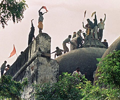 STILL BURNING: File photo shows the Babri Mosque being destroyed in Ayodhya