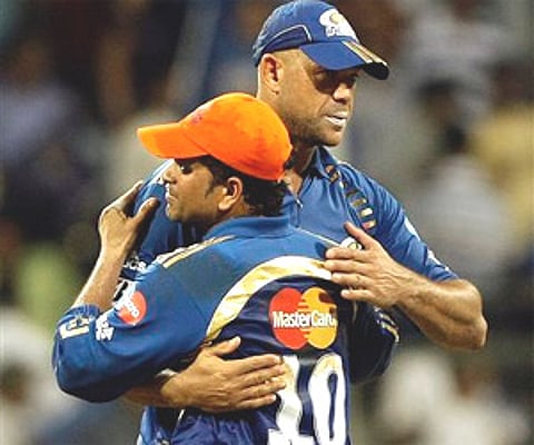 Mumbai Indians skipper Sachin Tendulkar and his teammate Andrew Symonds after they won the IPL match against Kings XI Punjab in Mumbai on Monday. AP