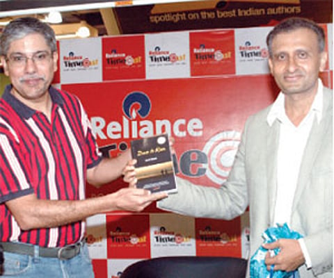 Sunil Chainani (left), a fellow marathon runner and author Amit Sheth at the launch of his book Dare to Run