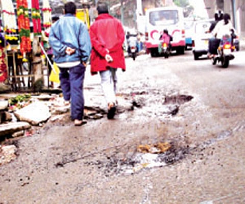 The landscape of CMH Road is dented with a number of potholes | express photo