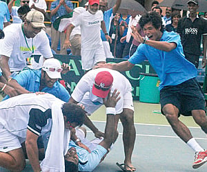 WE’VE DONE IT! Members of the national Davis Cup squad, including Somdev Devvarman (right) and Mahesh Bhupathi (left) rush to celebrate with Rohan Bop