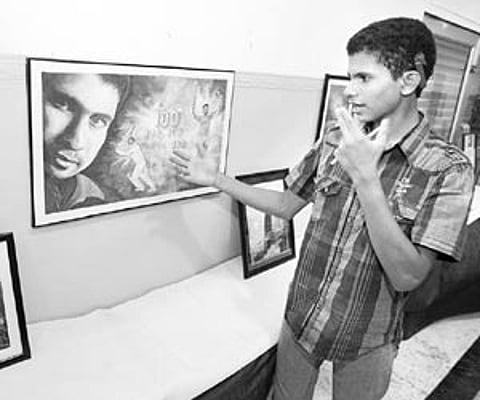 Rahul Ranjan showing a portrait of Sachin Tendulkar which he had painted after the maestro completed his century of centuries at ACA-VDCA Stadium on T