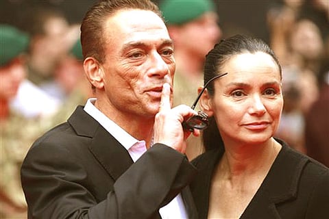 Cast member actor Jean-Claude Van Damme poses with his wife Gladys Portugues as he arrives for the UK premiere of 'The Expendables 2' in London (AP Photo/Sang Tan).