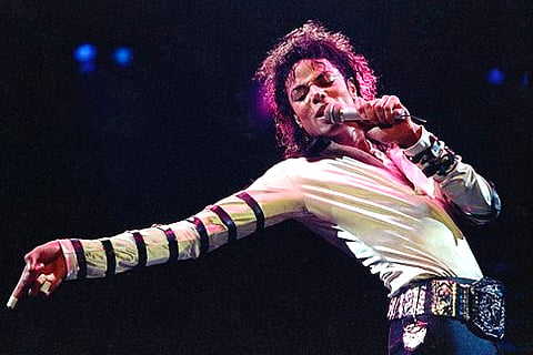 In this Feb. 24, 1988 file photo, Michael Jackson leans, points and sings, dances and struts during the opening performance of his 13-city U.S. tour, in Kansas City (AP Photo/Cliff Schiappa, File).