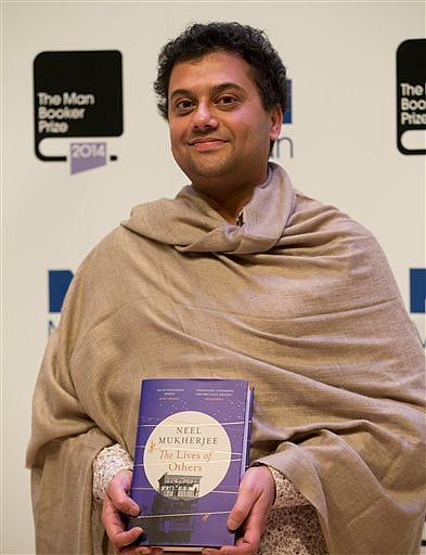 Man Booker prize 2014 nominee author Neel Mukherjee holds his book 'The Lives of Others' during a photocall for the Man Booker Prize for fiction 2014 at the Royal Festival Hall in London, Monday | AP