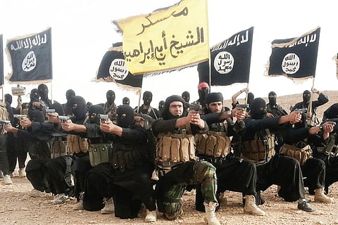 IS terror group members pose with their guns for a picture | File Photo