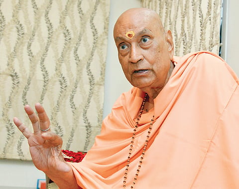 Pious Swami Kneels Before Mother India