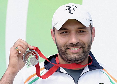 Silver medalist India's Harpreet Singh poses at the medal ceremony of the Men's 25m Rapid Fire Pistol event at the Commonwealth Games 2014 in Glasgow Scotland on Tuesday | PTI
