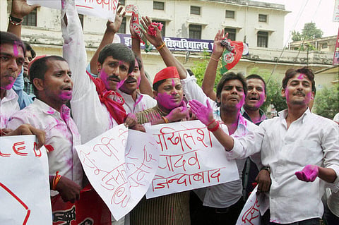 Samajwadi Party SP workers celebrate with colours to mark the party's victory in the Uttar Pradesh by-elections in Allahabad on Tuesday | PTI