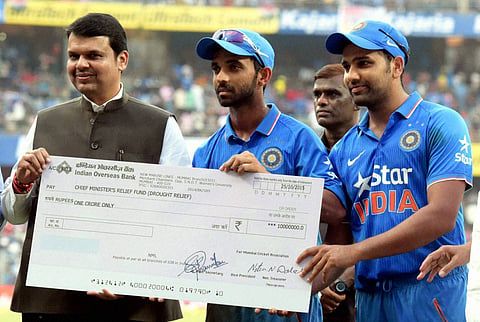 Mumbai Cricket Association MCA donates one crore rupees to Chief Minister Devendra Fadnavis for "CM Relief Fund" by hands of players Ajinkya Rahane and Rohit Sharma at Wankhede Stadium in Mumbai on Sunday. | PTI