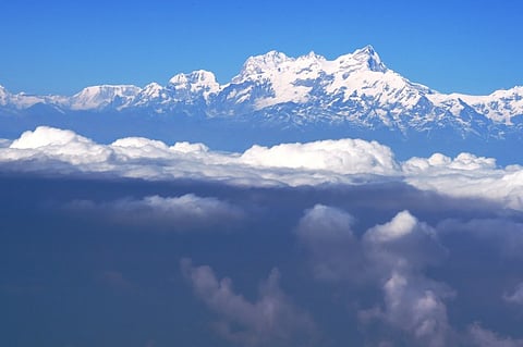 Himalaya range rise above the clouds.