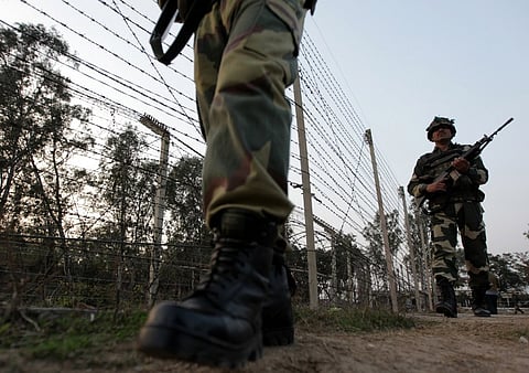 Indian Border Security Force (BSF) soldiers patrol along the border fence on the India-Pakistan border at Suchet Garh in Ranbir Singh Pura, about 36 kms from Jammu.