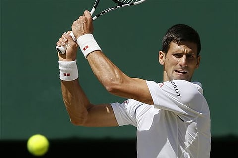 Novak Djokovic of Serbia returns a shot to Richard Gasquet of France during the men's singles semifinal match at the All England Lawn Tennis Championships in Wimbledon. |AP