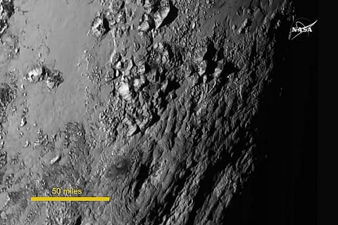 This file photo from NASA TV shows a detailed view of a portion of Pluto. |AFP