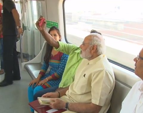 A passenger takes selfie with PM Narendra Modi on the Delhi Metro | ANI