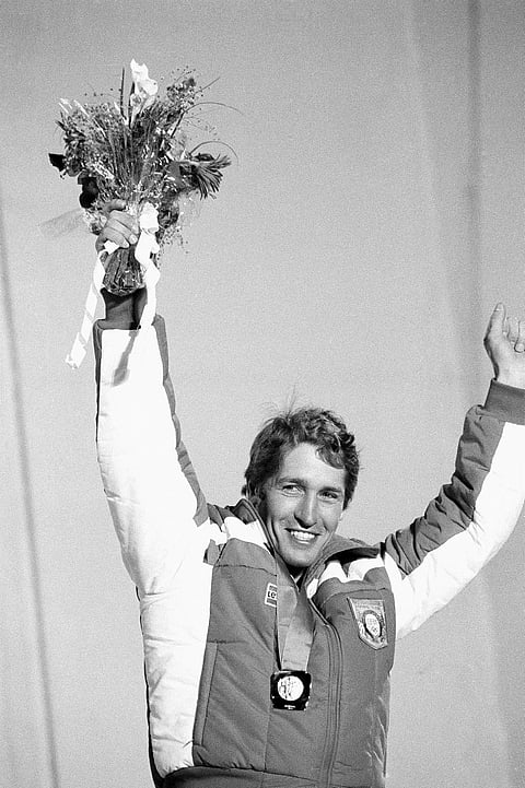 FILE - In this Feb. 16, 1984 file photo, Bill Johnson raises his arms into the air to celebrate his gold medal in the mens Olympic downhill in Sarajevo, Bosnia and Herzegovina. The U.S. ski team says the former Olympic downhill champion has died after a l