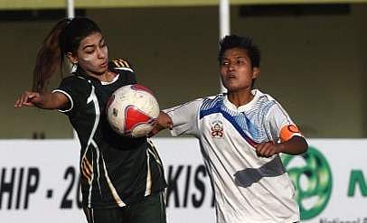 Pakistani forward Shahlyla Baloch (L) is in action during a football match. (File | AFP)
