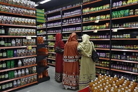 Customers shop inside a retail outlet at a shopping mall. (File | Reuters)