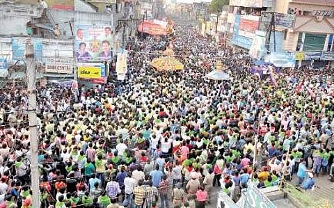 Devotees in lakhs participate in the Sirimanu Chariot procession on the streets of Vizianagaram on the second day of the Sirimanu Utsav on Tuesday. (Inset) Temple priest participating in the processio