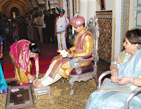 Trishika Kumari performing padapuja to Yaduveer Krishnadatta Chamaraja Wadiyar at Amba Vilas Palace in Mysuru on Saturday | Express