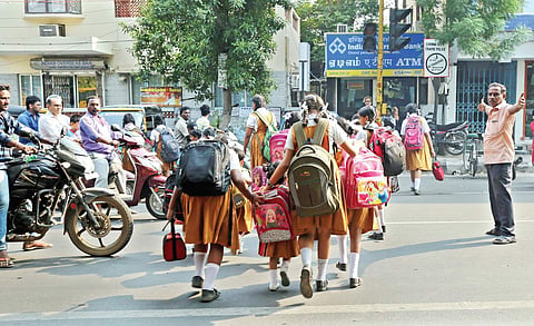 Children crossing a busy road as an auto driver takes the role of traffic police in Kilpauk | Romani Agarwal