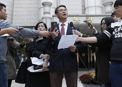 Attorney Peter Young-Yeel Ko speaks in front of the Seoul Central District Court in Seoul, South Korea, Monday, Oct. 24, 2016. Ko, head of the Harvest Law Firm, said that 527 consumers want Samsung to
