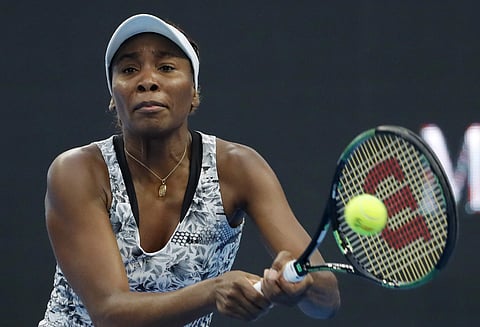 Venus Williams of the United States returns a shot against Peng Shuai of China during their women's singles match at the China Open tennis tournament at the National Tennis Stadium in Beijing. | AP