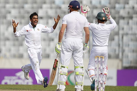 Bangladesh's Mehedi Hasan Miraz, left, celebrates with his team captain Mushfiqur Rahim, right, the dismissal of England's Jonny Bairstow. | AP