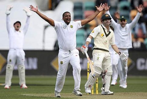 South Africa's Vernon Philander, second left, and teammates appeal for a lbw on Australia's David Warner, second right, during their cricket test match in Hobart, Australia. | AP