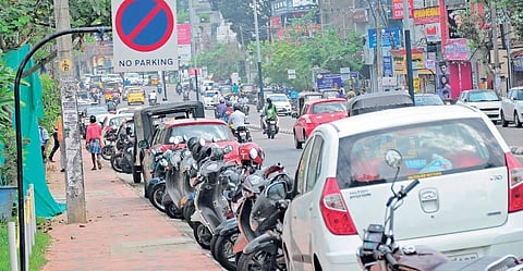 Vehicles parked under 'No Parking' sign at the first ever model road in the state, Vellayambalam-Sasthamangalam on Tuesday B P Deepu