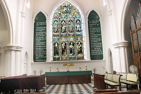 The stained-glass painting behind the altar.