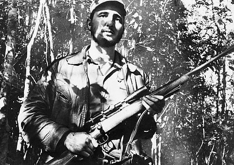 In this Feb. 26, 1957 file photo, Cuba's leader Fidel Castro stands in an unknown location in Cuba. | AP