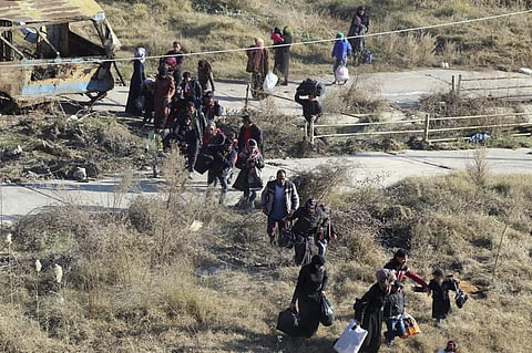 People fleeing rebel-held eastern neighborhoods of Aleppo into the Sheikh Maqsoud area that is controlled by Kurdish fighters. (Photo | AP)