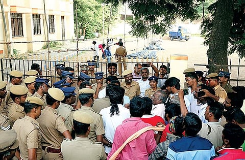 Residents arguing with policemen after the latter locked up the entrance to a playground, in Velachery on Monday | sunish p surendran