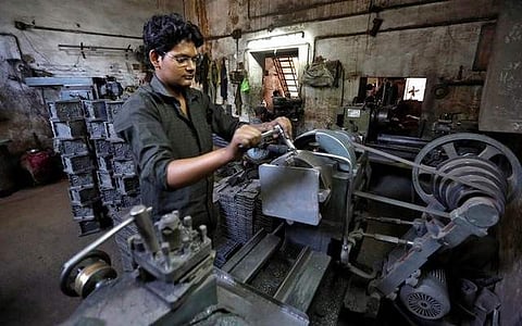 A worker operates a lathe inside a small-scale manufacturing unit in Ahmedabad. (Photo for representational purpose | Reuters)