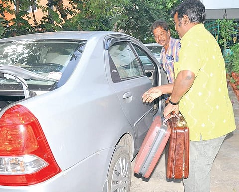 Officials of the Income Tax department with the cash, jewellery and documents seized from Shekar Reddy’s house in Katpadi. (File | EPS)