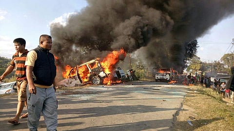 Angry people set on fire vehicles in Imphal East district on Sunday in protest against the United Naga Council’s indefinite economic blockade. | Express Photo Service