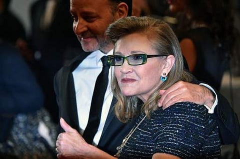 US actress Carrie Fisher poses with US actor and director Fisher Stevens at the 69th Cannes Film Festival in Cannes on May 14. (Photo | AFP)