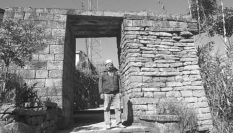 Methahetho Chase, grandson of ‘Naga father of Nation’ Angami Zapu Phizo, at the gate of Khonoma village in Nagaland on Tuesday; (Right) The memorial erected for the martyrs of war against the British