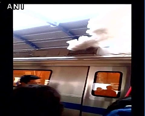 Smoke emits from a stationary metro train at Patel Nagar station. (Photo Courtesy: Twitter via @ANI_news)