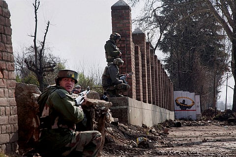 Security personnel take position outside the JKEDI building where militants have reportedly taken refuge after launching an attack on a CRPF convoy at Sampora Pampore near Srinagar on Sunday | PTI