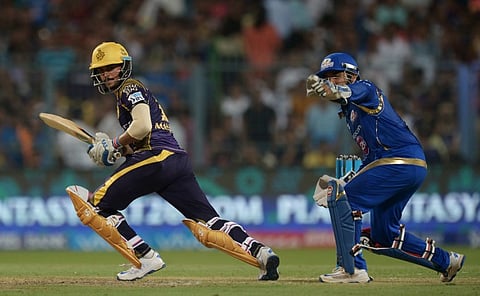 Kolkata Knight Riders cricketer Manish Pandey (L) is watched by Mumbai Indians cricketer Parthiv Patel as he plays a shot. | AFP