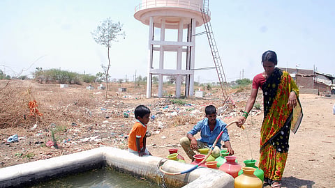 Villagers fill drinking water into plastic pots in a village in Mahabubnagar, one of the drought-affected districts in Telangana.