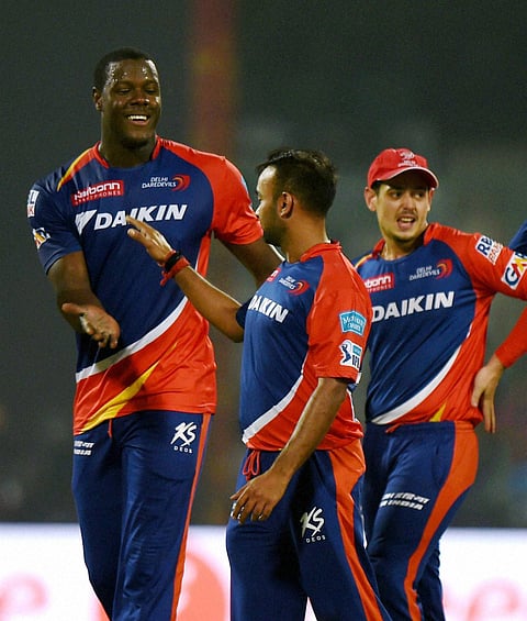 Delhi Daredevils players Carlos Brathwaite and Amit Mishra celebrate after their win over Kolkata Knight Rider during the IPL T20 match at Feroz Shah Kotla in New Delhi on Saturday. | PTI
