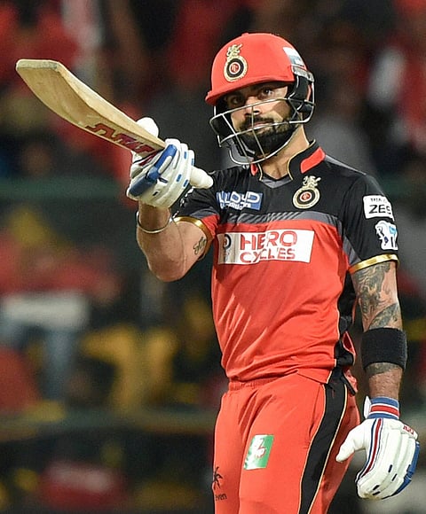 Royal Challengers Bangalore's Virat Kohli celebrates his fifty runs during an IPL 2016 match against Kings XI Punjab at Chinnaswamy Stadium in Bengaluru on Wednesday. | PTI