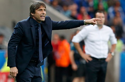 Italy's coach Antonio Conte, left, gives instructions to his players during the Euro 2016 Group E soccer match between Belgium and Italy at the Grand Stade in Decines-Charpieu, near Lyon, France, Monday, June 13, 2016. | AP