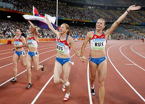 In this Friday, Aug. 22, 2008 file photo, Russia's Yuliya Chermoshanskaya, right, Yulia Gushchina, second left, Evgeniya Polyakova, left, and Aleksandra Fedoriva, second right, celebrate winning the gold in the women's 4x100-meter relay final at the Bei